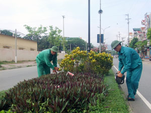Công nhân Công ty Môi trường đô thị Hòa Bình cắt tỉa cây cảnh làm đẹp cảnh quan phố phường.